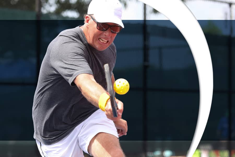 Photo of a man playing pickleball